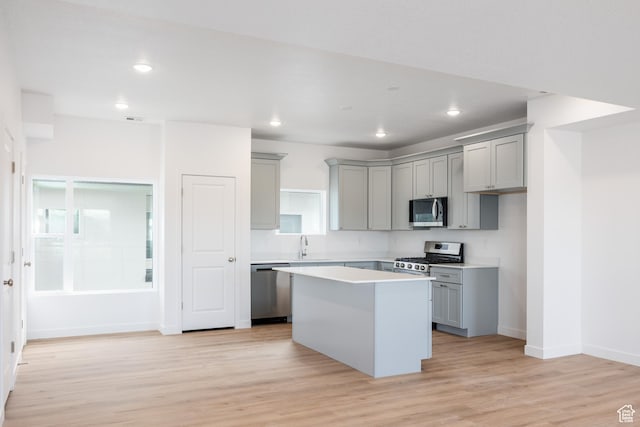 4479 S 500 E Unit 65, Millcreek, UT 84107 - kitchen featuring stainless steel appliances, light wood-type flooring, a kitchen island, light countertops, and gray cabinetry