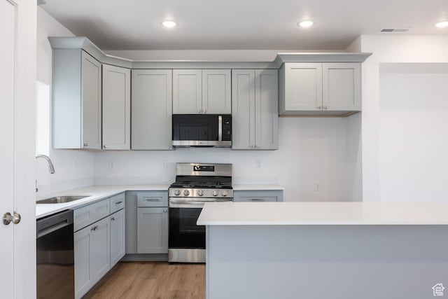 4479 S 500 E Unit 65, Millcreek, UT 84107 - kitchen featuring light wood finished floors, a sink, gray cabinets, visible vents, and appliances with stainless steel finishes