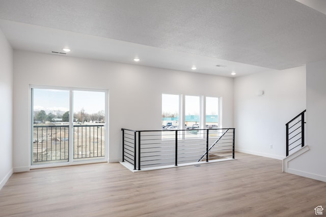 4479 S 500 E Unit 65, Millcreek, UT 84107 - spare room featuring wood finished floors, plenty of natural light, and baseboards