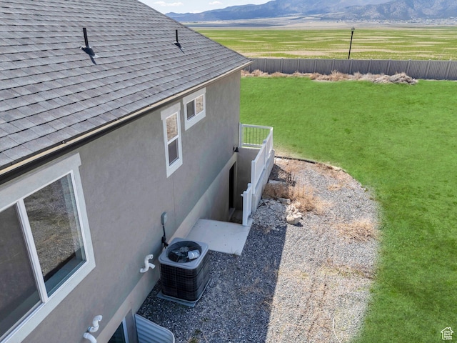 4867 N Canaan Peak Dr W, Eagle Mountain, UT 84005 - view of side of property with a mountain view, roof with shingles, stucco siding, and central air condition unit