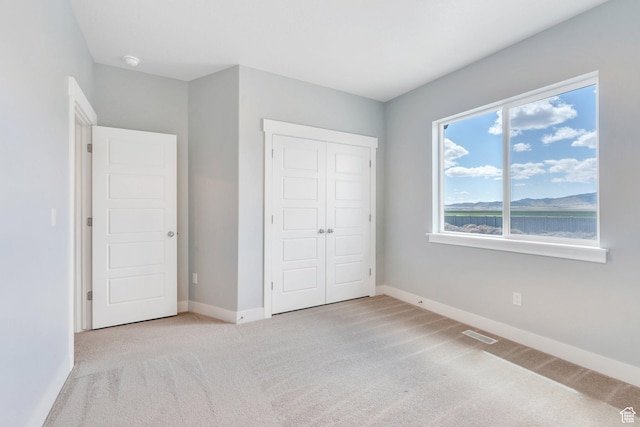 4867 N Canaan Peak Dr W, Eagle Mountain, UT 84005 - unfurnished bedroom featuring carpet flooring, baseboards, and a closet