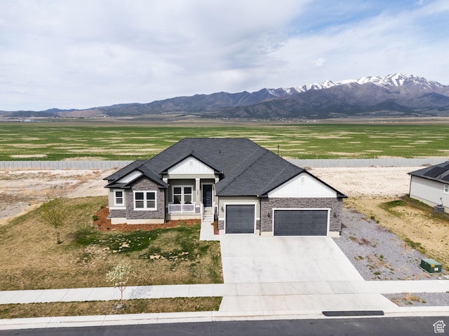4867 N Canaan Peak Dr W, Eagle Mountain, UT 84005 - view of front of house featuring an attached garage, driveway, a mountain view, and brick siding