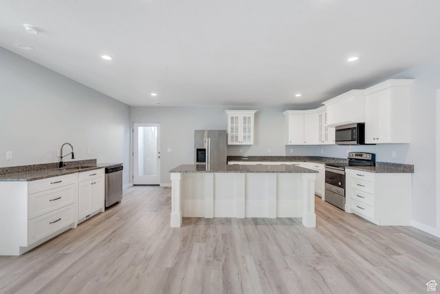 4867 N Canaan Peak Dr W, Eagle Mountain, UT 84005 - kitchen with appliances with stainless steel finishes, a sink, glass insert cabinets, white cabinets, and dark stone countertops
