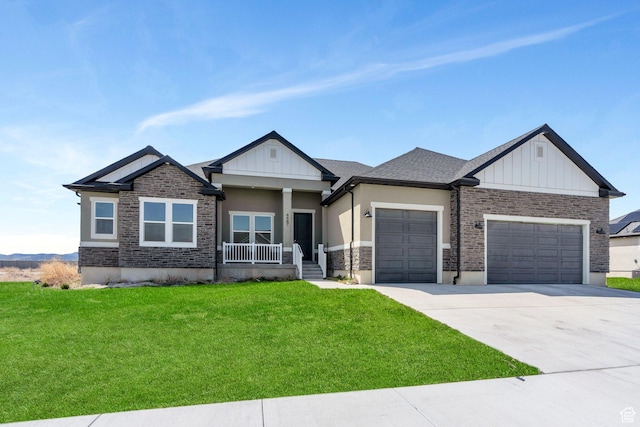 4867 N Canaan Peak Dr W, Eagle Mountain, UT 84005 - view of front of property featuring a garage, covered porch, a front yard, and board and batten siding
