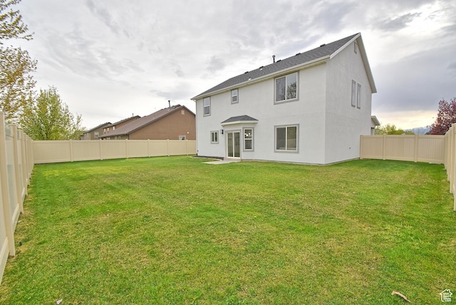 2041 S 750 E, Lehi, UT 84043 - rear view of property featuring a lawn, stucco siding, and a fenced backyard