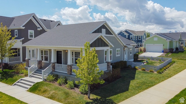 craftsman-style home featuring a porch, board and batten siding, a residential view, roof with shingles, and a garage