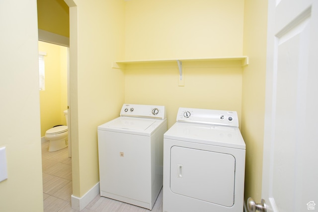 laundry room with independent washer and dryer and baseboards