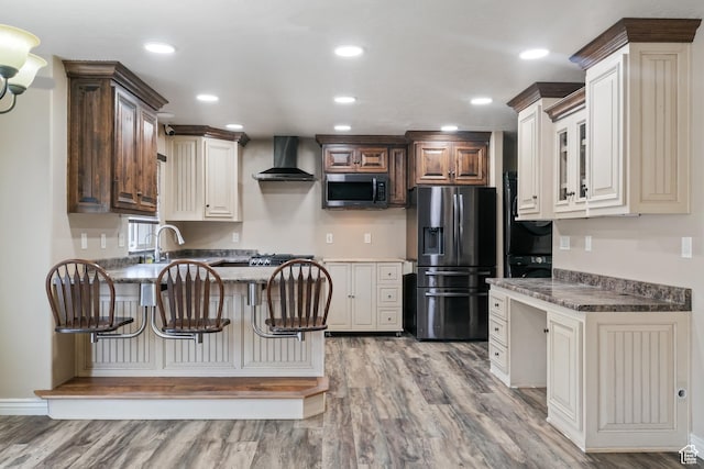 680 N 980 W, Tremonton, UT 84337 - kitchen with appliances with stainless steel finishes, a peninsula, light wood-style flooring, and wall chimney exhaust hood