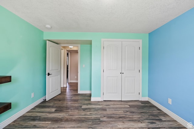 680 N 980 W, Tremonton, UT 84337 - unfurnished bedroom with dark wood-style floors, a closet, a textured ceiling, and baseboards