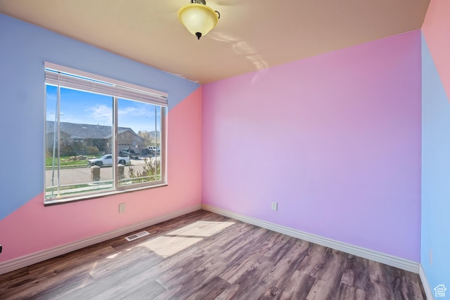 680 N 980 W, Tremonton, UT 84337 - unfurnished room featuring baseboards, visible vents, and wood finished floors