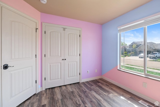 680 N 980 W, Tremonton, UT 84337 - unfurnished bedroom with wood finished floors, visible vents, baseboards, and a closet