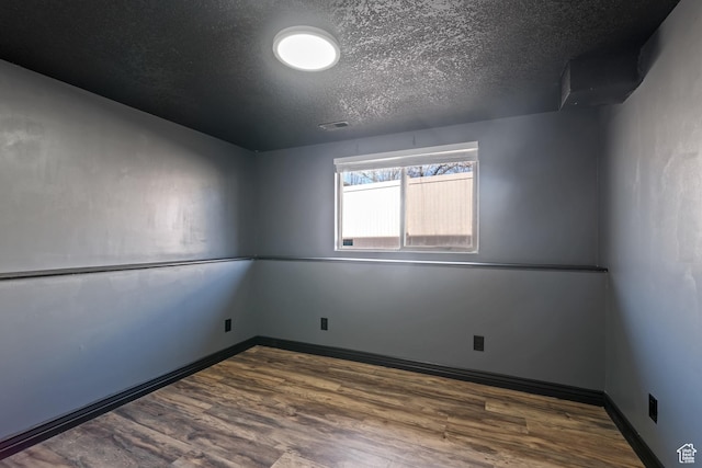 680 N 980 W, Tremonton, UT 84337 - spare room featuring a textured ceiling, wood finished floors, visible vents, and baseboards