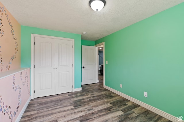 680 N 980 W, Tremonton, UT 84337 - unfurnished bedroom featuring a closet, a textured ceiling, wood finished floors, and baseboards