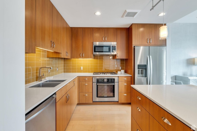 35 E 100 S Unit 1504, Salt Lake City, UT 84111 - kitchen featuring brown cabinetry, a sink, stainless steel appliances, and light countertops
