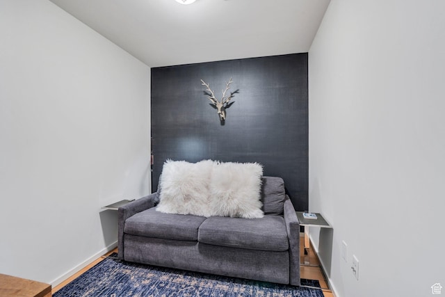 35 E 100 S Unit 1504, Salt Lake City, UT 84111 - living area with baseboards, an accent wall, and wood finished floors