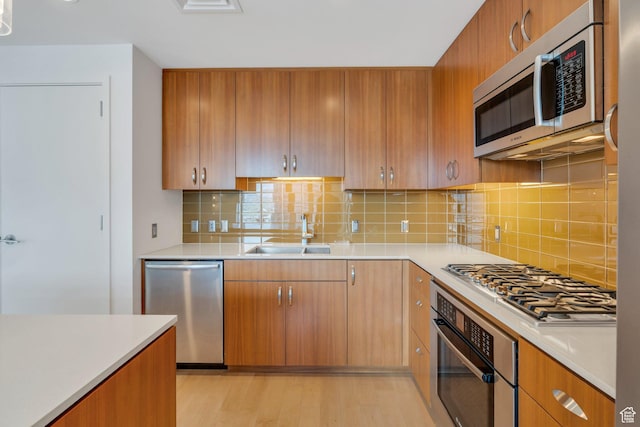 35 E 100 S Unit 1504, Salt Lake City, UT 84111 - kitchen featuring decorative backsplash, appliances with stainless steel finishes, light countertops, and a sink