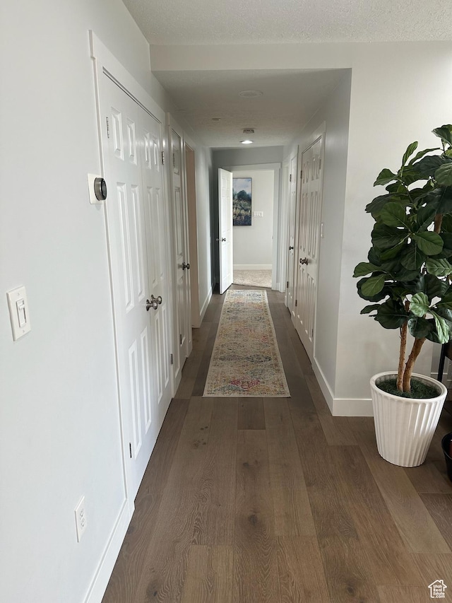 560 E S Temple St S Unit 302, Salt Lake City, UT 84102 - corridor featuring dark wood finished floors and baseboards