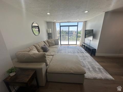 560 E S Temple St S Unit 302, Salt Lake City, UT 84102 - living room with a textured ceiling, a wall of windows, wood finished floors, and recessed lighting