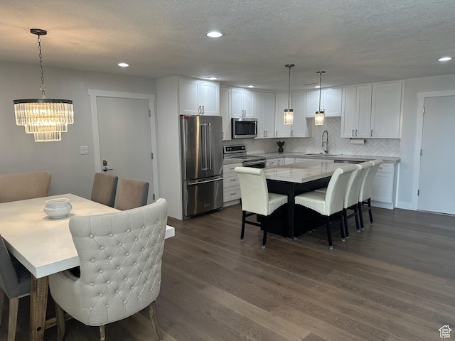 560 E S Temple St S Unit 302, Salt Lake City, UT 84102 - dining space with a chandelier, recessed lighting, and dark wood-style flooring