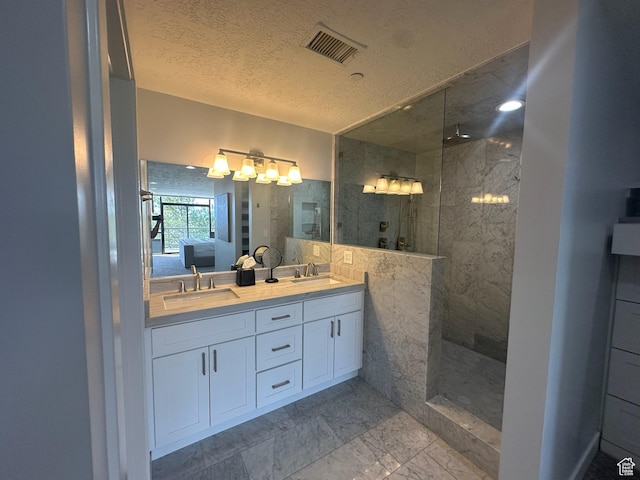 560 E S Temple St S Unit 302, Salt Lake City, UT 84102 - ensuite bathroom with walk in shower, visible vents, marble finish floor, and a sink