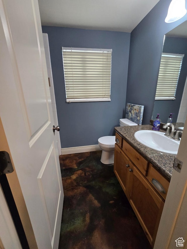 12075 S Draper Ridge Dr, Draper, UT 84020 - half bathroom featuring toilet, concrete flooring, vanity, and baseboards