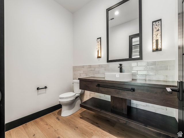 897 S Summit Creek Dr, Woodland Hills, UT 84653 - half bath with visible vents, toilet, wood finished floors, vanity, and backsplash