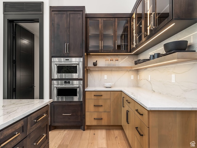 897 S Summit Creek Dr, Woodland Hills, UT 84653 - kitchen featuring tasteful backsplash, light wood-type flooring, light stone counters, and double oven