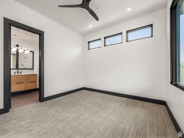 897 S Summit Creek Dr, Woodland Hills, UT 84653 - empty room featuring light carpet, a sink, baseboards, visible vents, and a ceiling fan