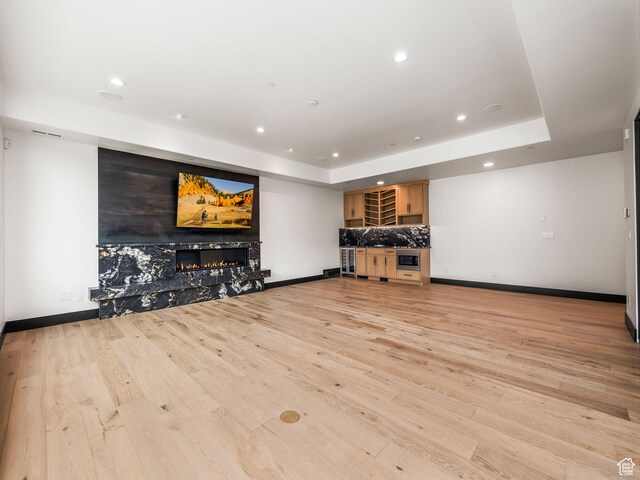 897 S Summit Creek Dr, Woodland Hills, UT 84653 - unfurnished living room with recessed lighting, a high end fireplace, light wood finished floors, baseboards, and visible vents
