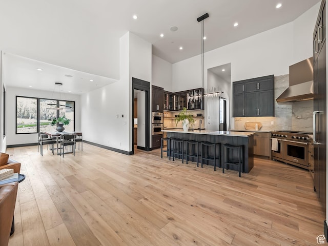 897 S Summit Creek Dr, Woodland Hills, UT 84653 - kitchen featuring double oven range, light countertops, a sink, a high ceiling, and a kitchen breakfast bar