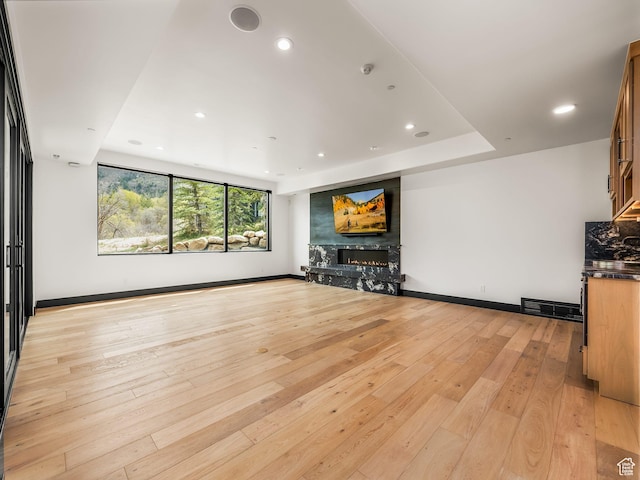 897 S Summit Creek Dr, Woodland Hills, UT 84653 - unfurnished living room featuring recessed lighting, visible vents, light wood-style flooring, baseboards, and a high end fireplace