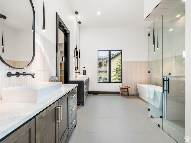 897 S Summit Creek Dr, Woodland Hills, UT 84653 - bathroom with a shower stall, a sink, two vanities, tile walls, and a freestanding tub