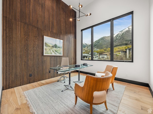897 S Summit Creek Dr, Woodland Hills, UT 84653 - home office featuring visible vents, wood finished floors, a mountain view, and a towering ceiling