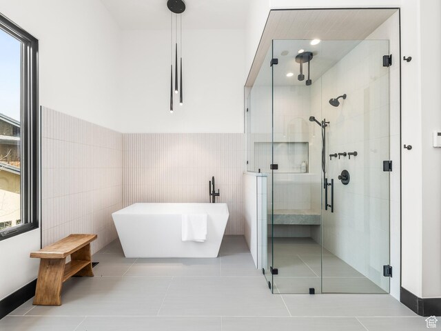 897 S Summit Creek Dr, Woodland Hills, UT 84653 - bathroom featuring tile walls, a freestanding tub, a stall shower, tile patterned flooring, and plenty of natural light