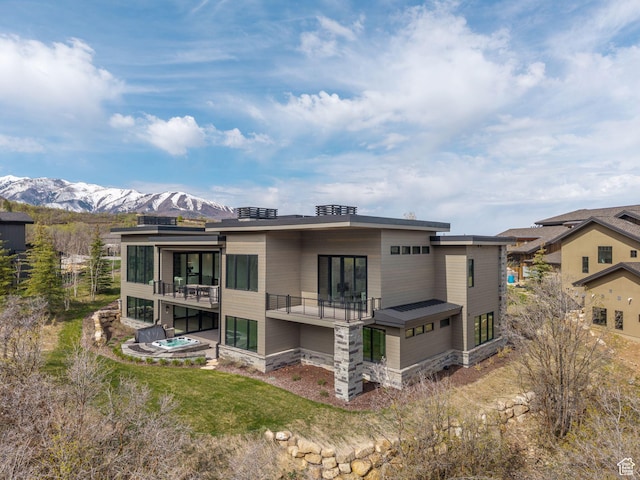 897 S Summit Creek Dr, Woodland Hills, UT 84653 - back of property with a balcony, a mountain view, and stone siding