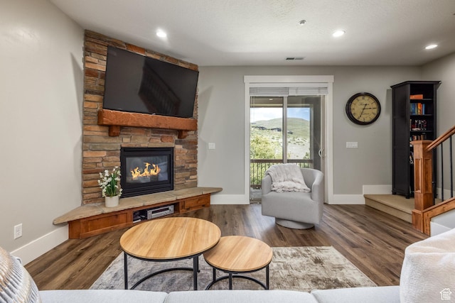 13386 N Alexis Dr, Kamas, UT 84036 - living room featuring a stone fireplace, wood finished floors, recessed lighting, and stairs