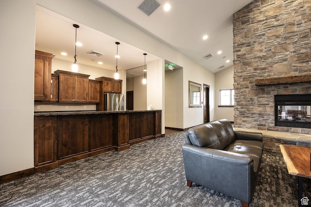 13386 N Alexis Dr, Kamas, UT 84036 - kitchen with freestanding refrigerator, open floor plan, vaulted ceiling, recessed lighting, and a stone fireplace