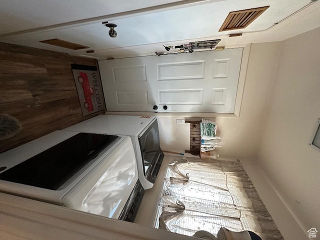 clothes washing area featuring visible vents and washing machine and dryer