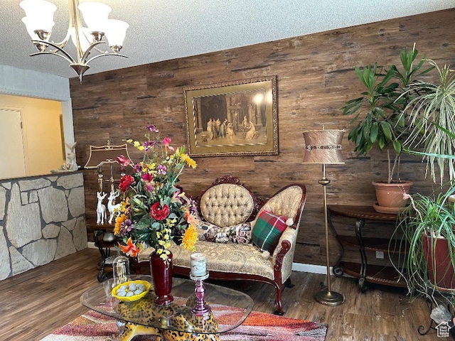interior space with wood finished floors, wooden walls, and a chandelier