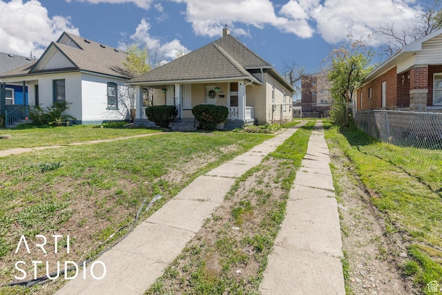233 Patterson St, Ogden, UT 84401 - bungalow-style house featuring driveway, roof with shingles, a front yard, fence, and a porch