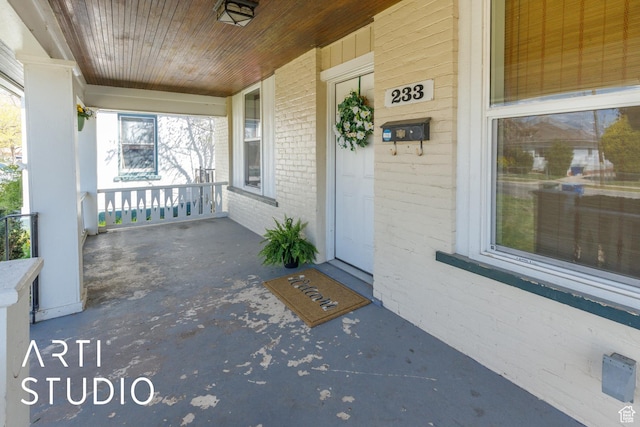 233 Patterson St, Ogden, UT 84401 - entrance to property featuring a porch and brick siding