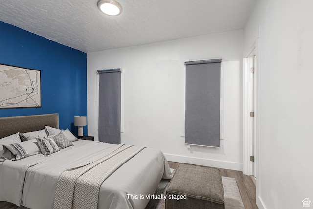 233 Patterson St, Ogden, UT 84401 - bedroom with a textured ceiling, wood finished floors, and baseboards