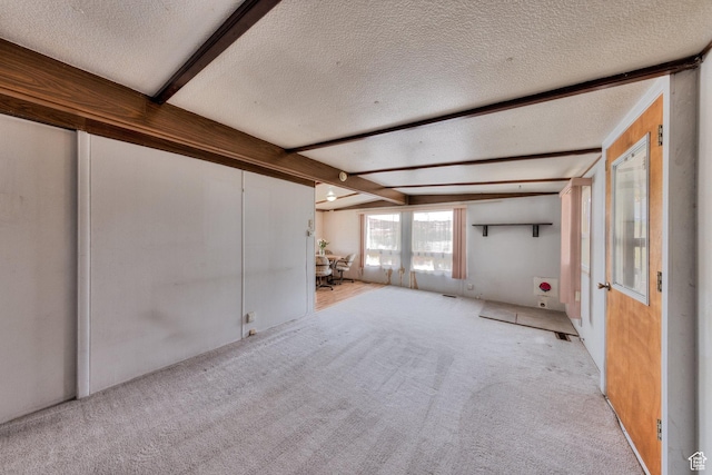 1575 Rocky Rd, Moab, UT 84532 - unfurnished living room with carpet flooring, a textured ceiling, and vaulted ceiling with beams