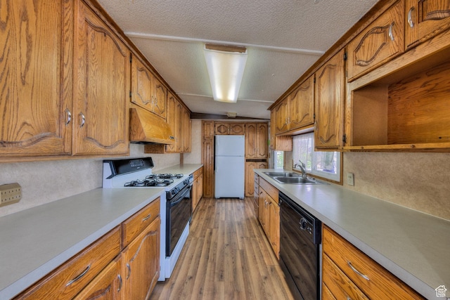 1575 Rocky Rd, Moab, UT 84532 - kitchen with freestanding refrigerator, gas range oven, custom range hood, a sink, and dishwasher