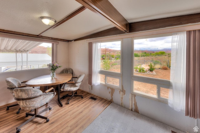 1575 Rocky Rd, Moab, UT 84532 - dining room with lofted ceiling with beams, plenty of natural light, and light wood-type flooring