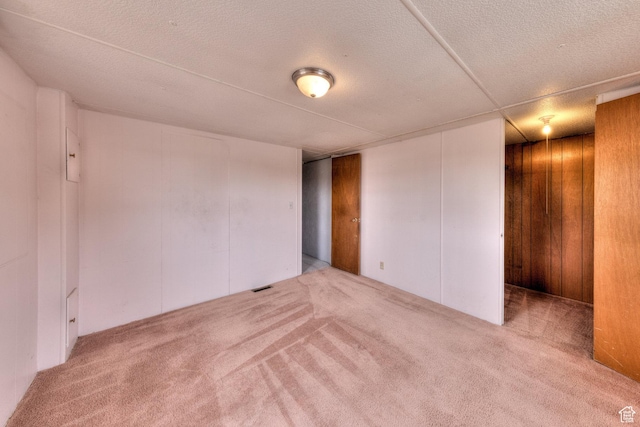 1575 Rocky Rd, Moab, UT 84532 - interior space with visible vents, wood walls, and a textured ceiling