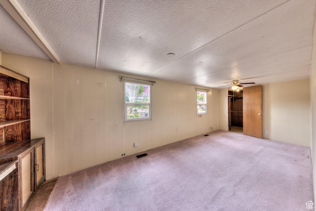 1575 Rocky Rd, Moab, UT 84532 - below grade area featuring carpet, a ceiling fan, a textured ceiling, and visible vents