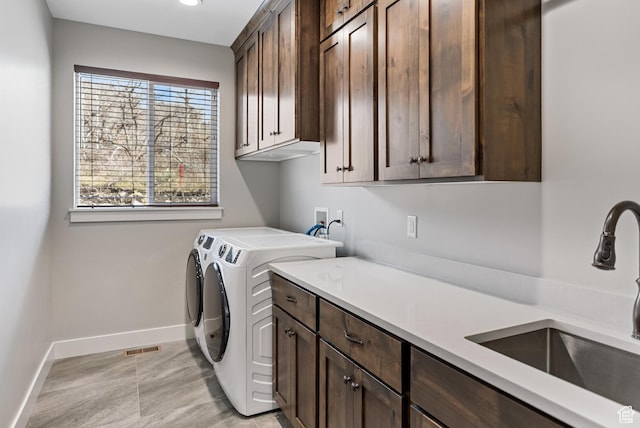 9313 E Deer Creek Dr S Unit 965, Heber City, UT 84032 - clothes washing area with a sink, visible vents, baseboards, washer and dryer, and cabinet space