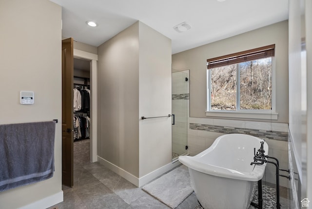 9313 E Deer Creek Dr S Unit 965, Heber City, UT 84032 - bathroom with recessed lighting, a shower stall, tile walls, a soaking tub, and a spacious closet