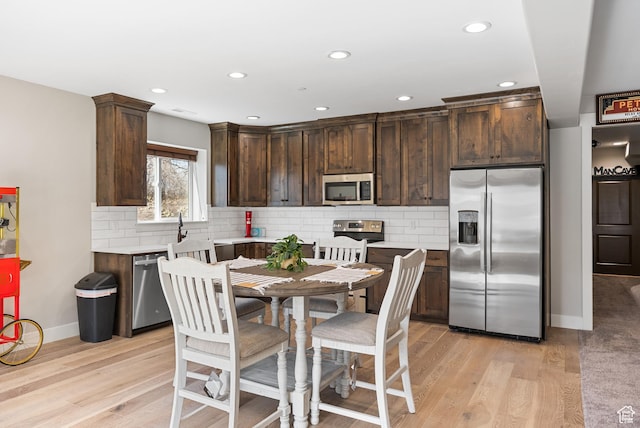9313 E Deer Creek Dr S Unit 965, Heber City, UT 84032 - kitchen with stainless steel appliances, light countertops, light wood finished floors, and dark brown cabinetry